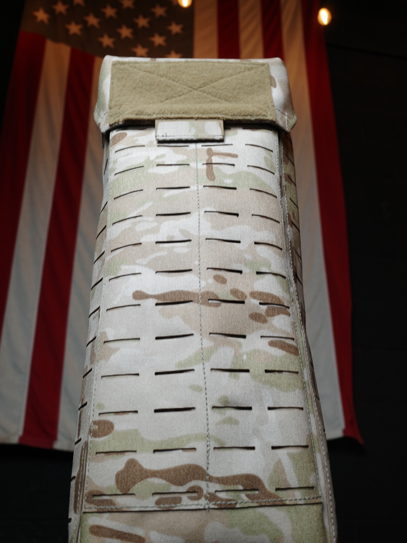 Fieldcraft glove bag in MultiCam Arid standing tall in front of an American flag