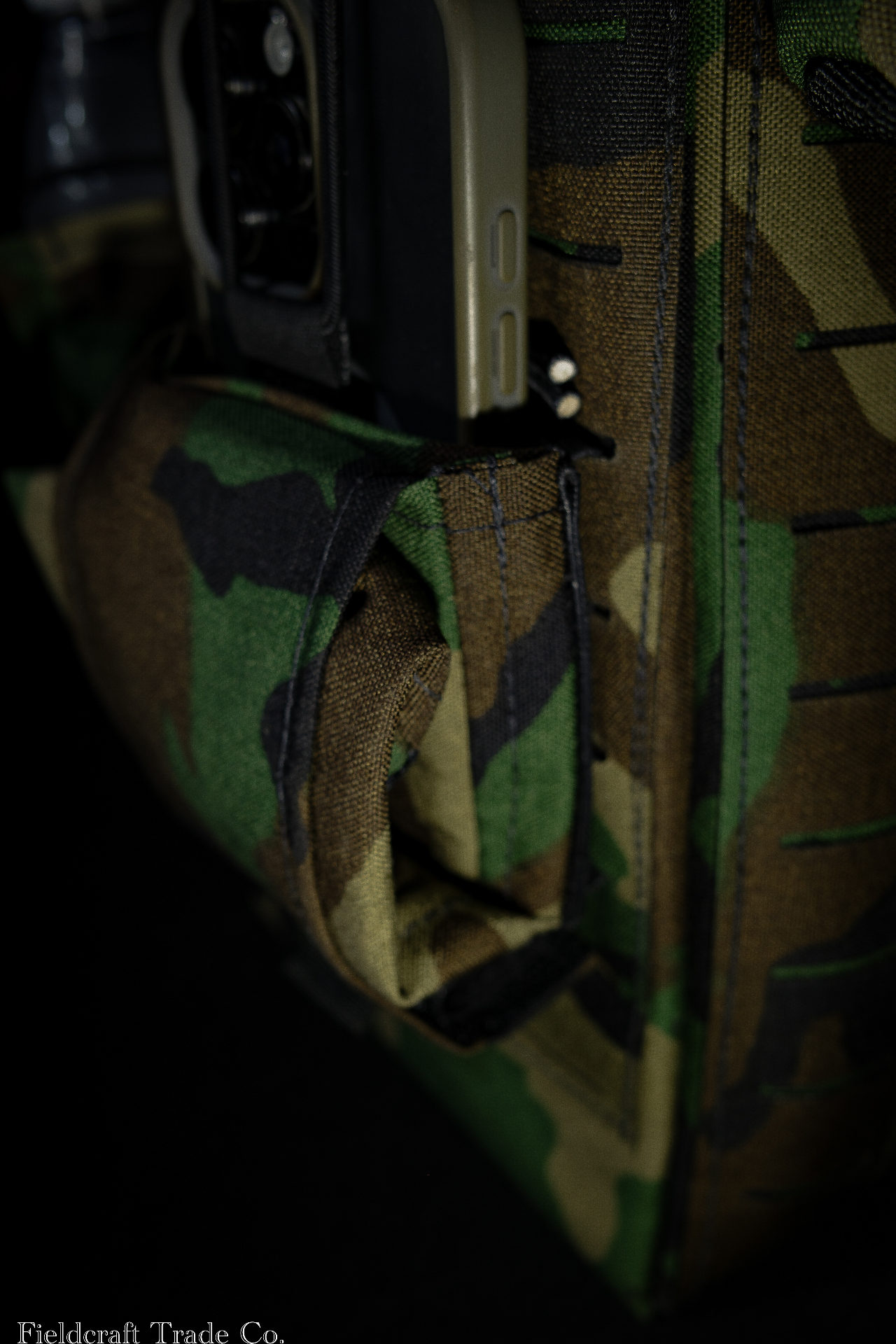 Macro detail of the M81 Woodland glove bag's magnet closure and laser-cut MOLLE stitching